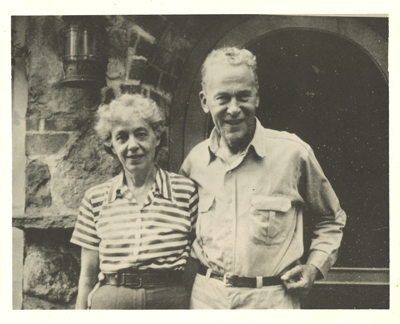 Maud & Miska Petersham standing in front of a stone entryway.